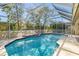 Enclosed swimming pool featuring sparkling blue water and clear views of the landscaped backyard at 4410 Murfield E Dr, Bradenton, FL 34203