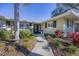 Close-up of the front entrance with well-maintained landscaping and a charming walkway leading to the front door at 5211 Carmilfra Dr, Sarasota, FL 34231