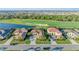 Upscale homes overlook the golf course, lush green landscaping, and blue pond at 5529 Mulligan Way, Bradenton, FL 34211