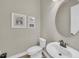 This powder room includes a pedestal sink and decorative wall art at 5529 Mulligan Way, Bradenton, FL 34211