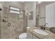 This bathroom features a tile shower, granite countertops, and modern fixtures at 5529 Mulligan Way, Bradenton, FL 34211