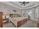 Comfortable bedroom featuring a ceiling fan, natural light, and a decorative side table at 5529 Mulligan Way, Bradenton, FL 34211