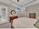 Bright bedroom featuring a ceiling fan, TV, natural light, and a decorative mirror and dresser at 5529 Mulligan Way, Bradenton, FL 34211