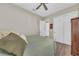 Cozy bedroom features wood-look flooring, a ceiling fan, and a double-door closet at 5529 Mulligan Way, Bradenton, FL 34211