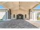 Elegant clubhouse entrance with stone pillars, arched openings, and a meticulously paved driveway creating a grand arrival at 5529 Mulligan Way, Bradenton, FL 34211