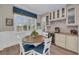 Cozy breakfast nook with bright windows and custom cabinetry with a wine fridge at 5529 Mulligan Way, Bradenton, FL 34211