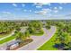 Beautiful aerial view of the entrance to a Primary planned community with lush landscaping and mature palm trees at 5529 Mulligan Way, Bradenton, FL 34211