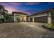 Beautiful curb appeal with lush landscaping, paver driveway and two car garage at 5529 Mulligan Way, Bradenton, FL 34211