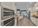 Well-lit kitchen with stainless steel appliances, granite countertops, and light wood cabinets at 5529 Mulligan Way, Bradenton, FL 34211