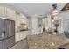 Spacious kitchen featuring granite countertops, stainless steel appliances, and light wood cabinets at 5529 Mulligan Way, Bradenton, FL 34211