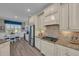 Bright kitchen with stainless steel appliances, granite countertops, and light wood cabinets at 5529 Mulligan Way, Bradenton, FL 34211