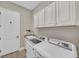 This laundry room features modern appliances, ample cabinet space, and granite countertops at 5529 Mulligan Way, Bradenton, FL 34211