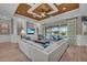Cozy living room with coffered ceiling, built-ins, and a view of the outdoor patio at 5529 Mulligan Way, Bradenton, FL 34211