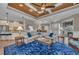 Open-concept living room with wood ceilings and views into the kitchen and dining area at 5529 Mulligan Way, Bradenton, FL 34211