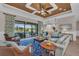 This spacious living room features a decorative ceiling, stylish furnishings, and backyard views at 5529 Mulligan Way, Bradenton, FL 34211