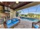 This screened patio features an outdoor kitchen, seating, and pool views at 5529 Mulligan Way, Bradenton, FL 34211
