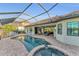 Enjoy this backyard pool and patio area with a spa, outdoor kitchen, and comfortable seating at 5529 Mulligan Way, Bradenton, FL 34211