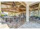 Outdoor bar with tables and chairs, ceiling fans, and a clear view of palm trees and blue sky at 5529 Mulligan Way, Bradenton, FL 34211