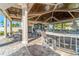 Exterior pool bar area with ceiling fans, dining tables, and a beautiful patio at 5529 Mulligan Way, Bradenton, FL 34211