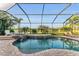 Relaxing screened pool with spa, lush landscape views and inviting lounge area at 5529 Mulligan Way, Bradenton, FL 34211