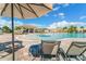 Relaxing pool area with shaded lounge chairs and umbrellas at 5529 Mulligan Way, Bradenton, FL 34211