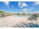 A wide pool area offers lounge chairs, umbrellas, waterfall features, and crystal-clear swimming water at 5529 Mulligan Way, Bradenton, FL 34211