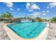 A large pool boasts a stunning rock waterfall feature with clear blue water and plenty of space for swimming at 5529 Mulligan Way, Bradenton, FL 34211