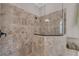 Modern tiled shower with a glass enclosure and decorative tile accents at 5529 Mulligan Way, Bradenton, FL 34211