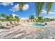 Relaxing spa area with a small rock waterfall feature, lounge chairs, and a disability chair lift at 5529 Mulligan Way, Bradenton, FL 34211