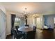 Dining room featuring a modern chandelier, round table with chairs, and sliding glass doors for natural light at 603 Verrocchio Dr # 603, Nokomis, FL 34275