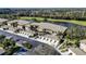 Scenic aerial shot of well-maintained condos situated near a picturesque lake and golf course at 6326 Grand Oak Cir # 101, Bradenton, FL 34203