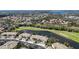 Expansive aerial view of condos adjacent to a beautiful lake and a manicured golf course at 6326 Grand Oak Cir # 101, Bradenton, FL 34203