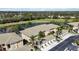 Scenic aerial view of condo with lush landscaping, a community pond, and a golf course in the background at 6326 Grand Oak Cir # 101, Bradenton, FL 34203