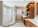 Bathroom featuring a glass enclosed shower, double sink vanity, and natural light at 6326 Grand Oak Cir # 101, Bradenton, FL 34203
