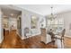 Dining room with round glass table, decorative mirror, hanging light fixture, and hardwood floors at 6326 Grand Oak Cir # 101, Bradenton, FL 34203