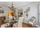 Dining room with round glass table, decorative mirror, hanging light fixture, and hardwood floors at 6326 Grand Oak Cir # 101, Bradenton, FL 34203