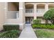 Welcoming condo entrance with well-maintained landscaping and a private balcony, creating a serene outdoor space at 6326 Grand Oak Cir # 101, Bradenton, FL 34203