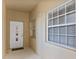 Condo entryway featuring the front door with sidelight windows providing natural light to the space at 6326 Grand Oak Cir # 101, Bradenton, FL 34203