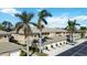 Charming condo complex with tile roof and attached garages, surrounded by mature palm trees and greenery at 6326 Grand Oak Cir # 101, Bradenton, FL 34203