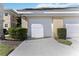 Attached one car garage with concrete driveway and well-maintained landscaping in front of residential building at 6326 Grand Oak Cir # 101, Bradenton, FL 34203
