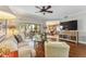 Bright living room featuring stylish decor, a ceiling fan, a view to the kitchen, and an outdoor dining area at 6326 Grand Oak Cir # 101, Bradenton, FL 34203