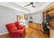 Comfortable living room featuring wood floors, a ceiling fan and a built-in desk with storage at 6326 Grand Oak Cir # 101, Bradenton, FL 34203