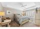 Main bedroom with tray ceilings, carpet, large windows with shutters, and comfortable king bed at 6326 Grand Oak Cir # 101, Bradenton, FL 34203
