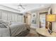 Main bedroom with tray ceilings, carpet, large windows with shutters, and access to bathroom at 6326 Grand Oak Cir # 101, Bradenton, FL 34203