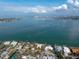 Waterfront homes with mature trees with views of the bay in this aerial view at 679 Norsota Way, Sarasota, FL 34242