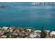 Panoramic aerial view showing a waterfront home nestled amongst lush landscaping at 679 Norsota Way, Sarasota, FL 34242