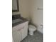 Well-lit bathroom with granite vanity, white cabinet, and tiled floors at 7211 W Country Club N Dr # 135, Sarasota, FL 34243