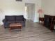 Neutral living room with hard surface flooring, a plush sofa, and side tables at 7211 W Country Club N Dr # 135, Sarasota, FL 34243