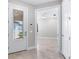 Foyer access to a light-filled bedroom with tile floors, a ceiling fan, and a window at 7629 Summerland Cv, Bradenton, FL 34202