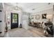 Bright foyer featuring a modern light fixture, complemented by views of the dining area and office at 7731 Camden Harbour Dr, Bradenton, FL 34212